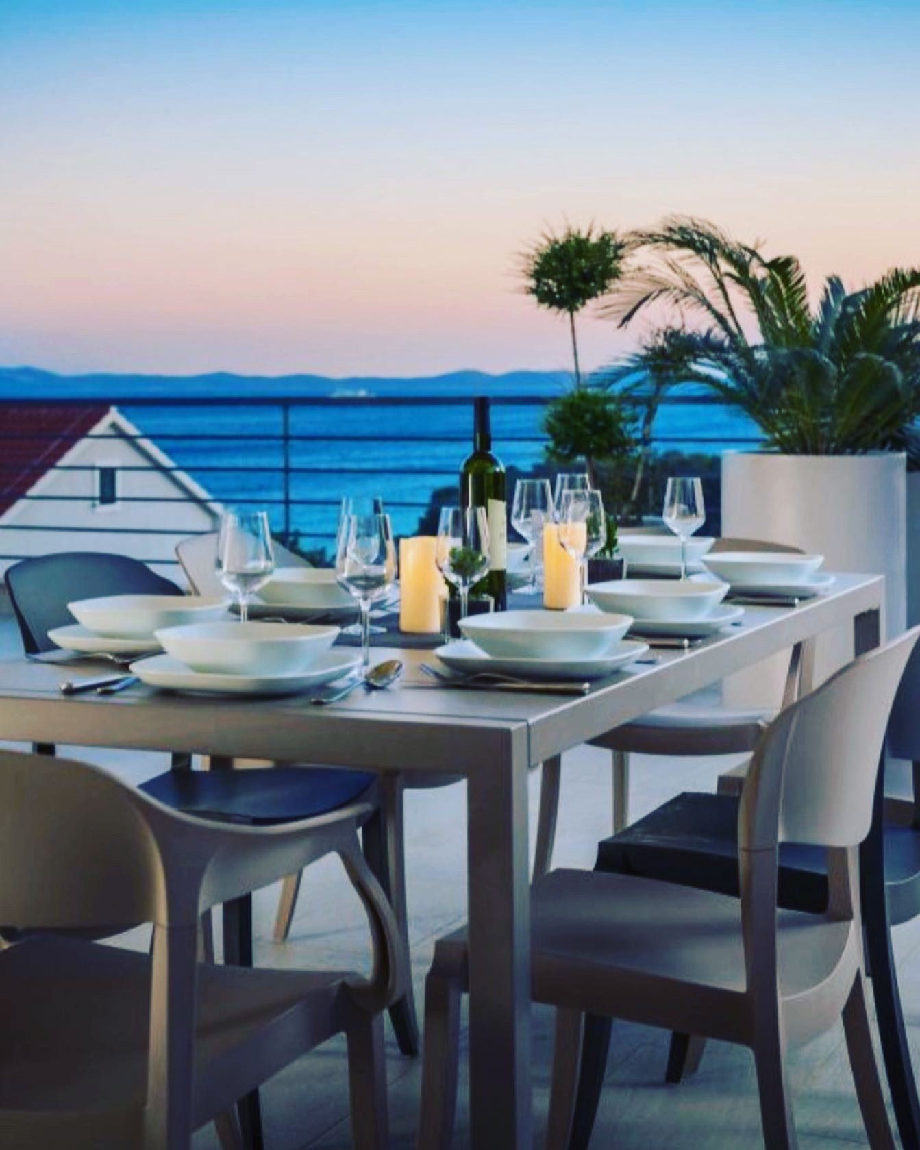 Villa terrace set for dinner at dusk