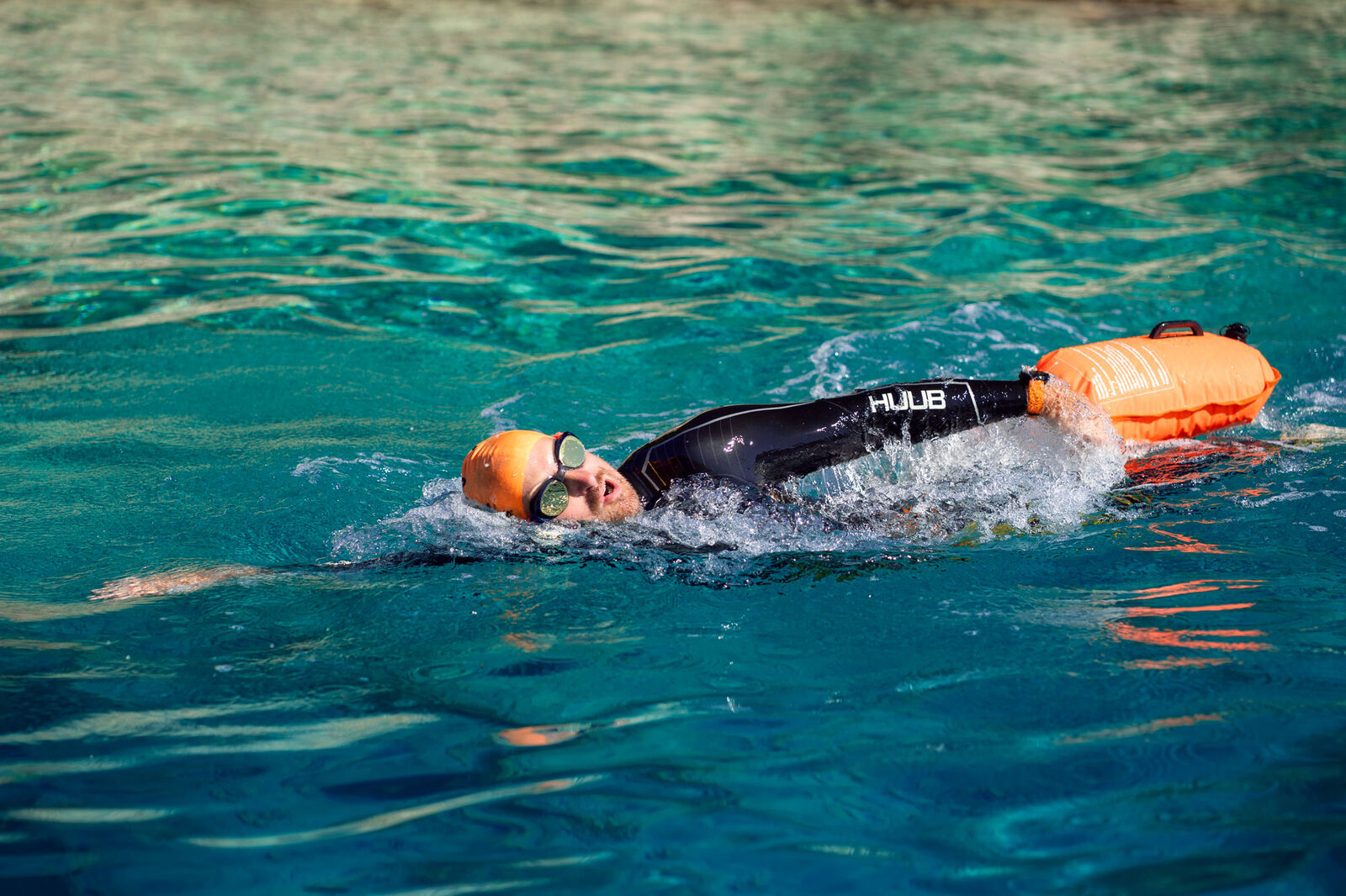 Open water swimmer with HUUB tow float